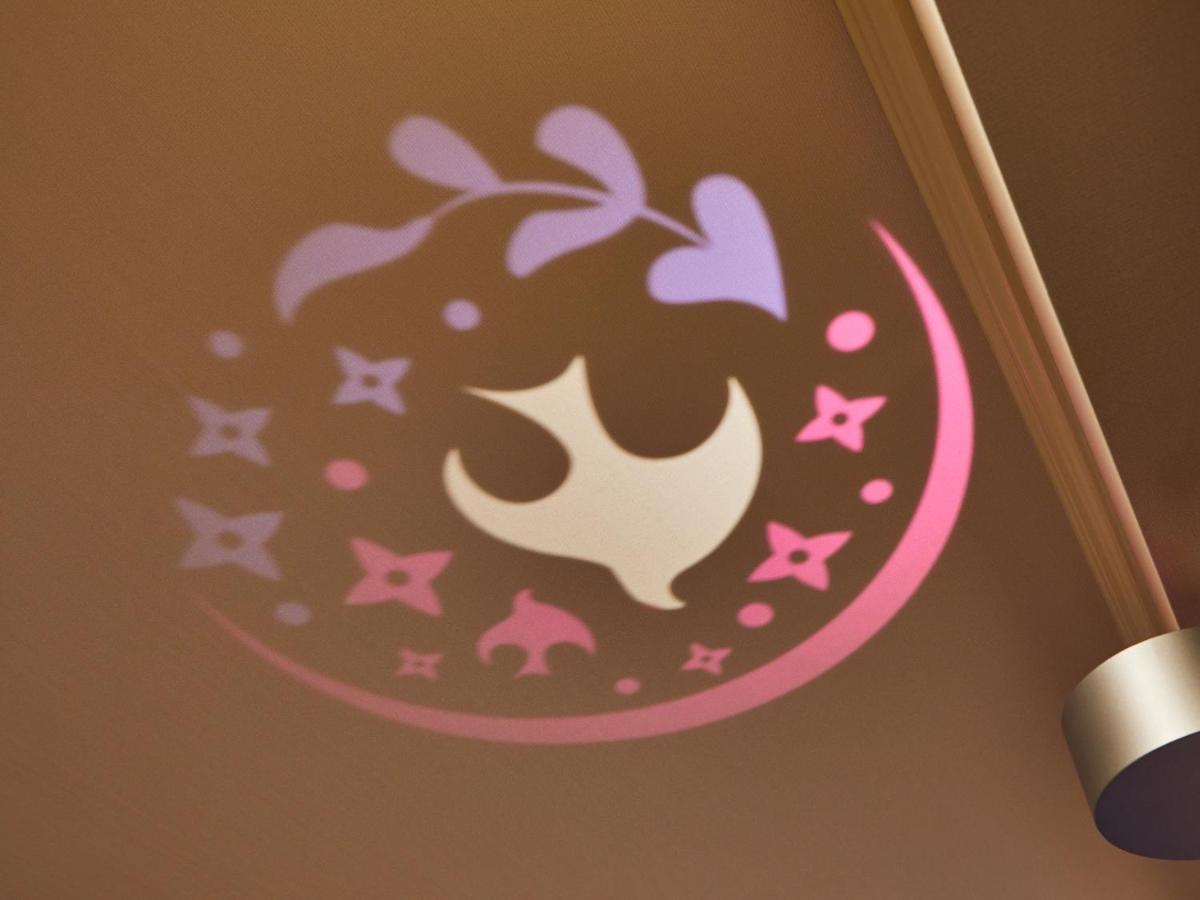 Grand Nikko Tokyo Bay Maihama Hotel Urajaszu Kültér fotó The image shows a projection on a surface, featuring a circular design with a mix of colors, primarily pink and purple. The design includes a white dove, which is likely a symbol of peace, surrounded by decorative elements such as leaves and small st